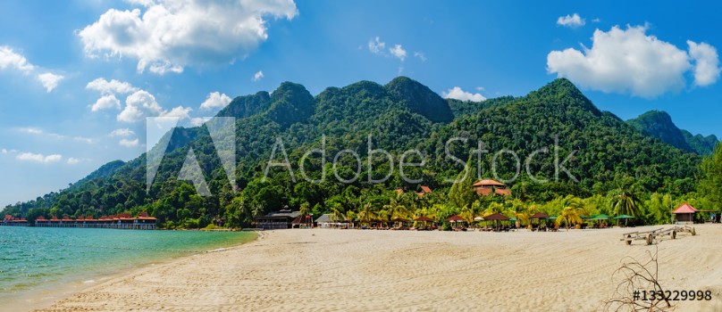 Bild på Relaxing on remote paradise beach Tropical bungalow and luxury house on untouched sandy beach with palms trees in Langkawi Island Malaysia